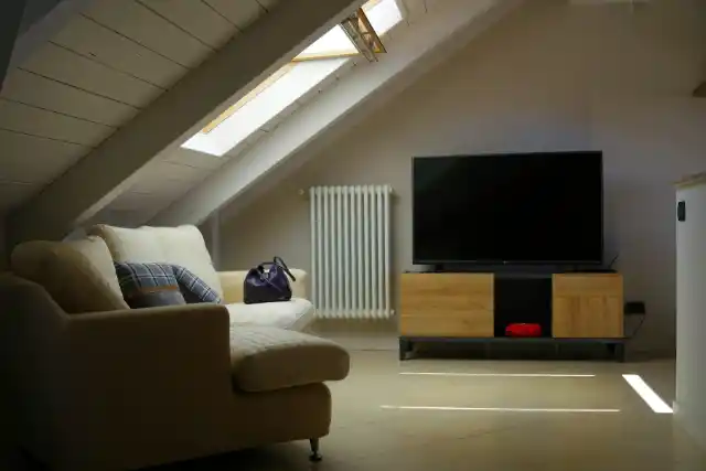 a living room with a tv and couches